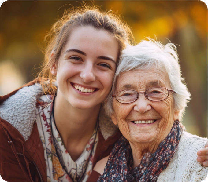 Young woman and elderly woman embracing showing caregiver confidence through KISA GPS tracking for elderly safety
