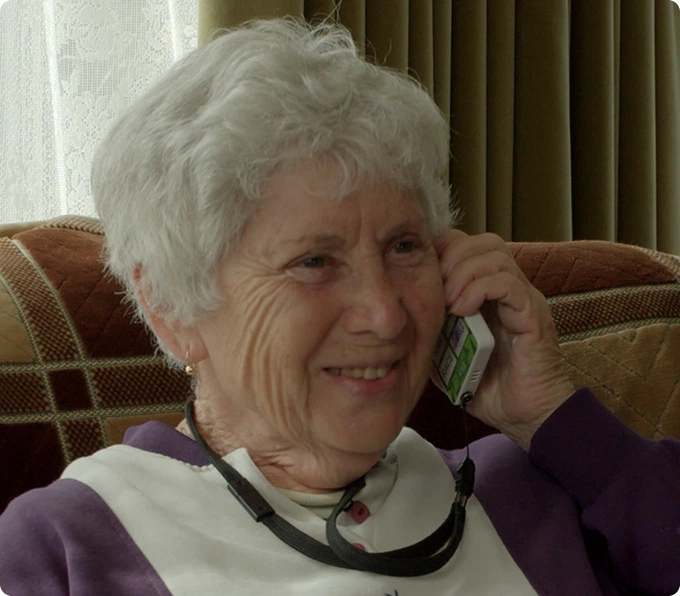 Elderly woman talking on phone showing KISA Telephony Service simple reliable communication for seniors